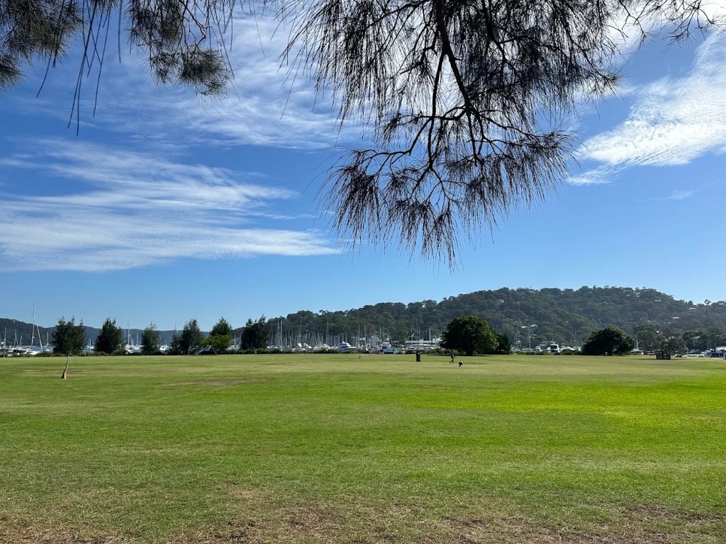 Rowland Reserve — grassy off-leash area and Pittwater boats